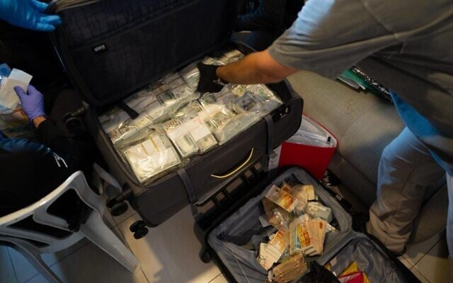 Large amounts of cash, both US dollars and Israeli shekels, stored in suitcases that were seized by police during a raid on a drug lab in the Ashdod area on November 16, 2025. (Israel Police) Large amounts of cash, both US dollars and Israeli shekels, stored in suitcases that were seized by police during a raid on a drug lab in the Ashdod area on November 16, 2025. (Israel Police)