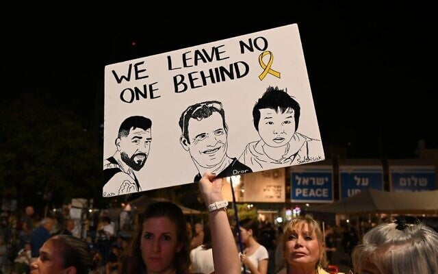 At the November 22, 2025 rally for the hostages in Tel Aviv's Hostages Square, a sign portraying remaining hostages (L-R) Ran Gvili, Dror Or and Sudthisak Rinthalak (Paulina Patimer/Hostages Forum)