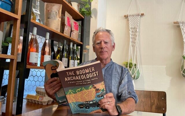 Archaeologist Thomas Levy with his new memoir 'The Boomer Archaeologist,' in Jerusalem in September 2025. (Rossella Tercatin/Times of Israel)