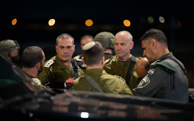 IDF Chief of Staff Lt. Gen. Eyal Zamir (left) and Judea and Samaria Division commander Brig. Gen. Kobi Heller (right) speak with other officers at the Gush Etzion Junction in the West Bank, following a terror attack, November 18, 2025. (Israel Defense Forces)