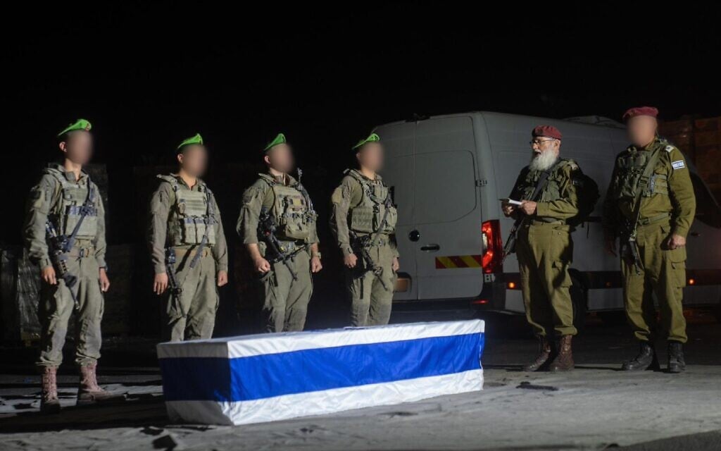 IDF troops stand next the casket containing the body of hostage Meny Godard after it was returned by Hamas, during a short ceremony led by IDF Chief Rabbi Brig. Gen. Eyal Krim (right) in the Gaza Strip, November 13, 2025. (Israel Defense Forces)