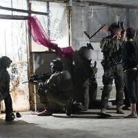 Troops of the 55th Reserve Paratroopers Brigade detain a suspect in the southern Syrian village of Beit Jinn, early November 28, 2025. (Israel Defense Forces)