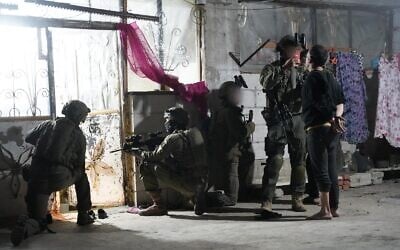 Troops of the 55th Reserve Paratroopers Brigade detain a suspect in the southern Syrian village of Beit Jinn, early November 28, 2025. (Israel Defense Forces)