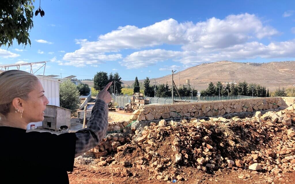 On her backyard terrace in Avivim, Limor Biton points to a hill in Lebanon and Bint Jbeil, a Hezbollah stronghold, on November 26, 2025. (Diana Bletter/Times of Israel) On her backyard terrace in Avivim, Limor Biton points to a hill in Lebanon and Bint Jbeil, a Hezbollah stronghold, on November 26, 2025. (Diana Bletter/Times of Israel)