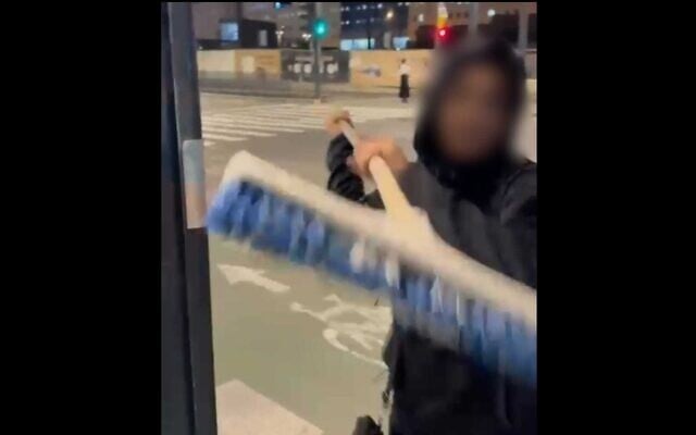 A teenager is filmed assaulting a bus driver with a broom outside the Central Bus Station in Jerusalem on November 22, 2025. (Israel Police) A teenager is filmed assaulting a bus driver with a broom outside the Central Bus Station in Jerusalem on November 22, 2025. (Israel Police)