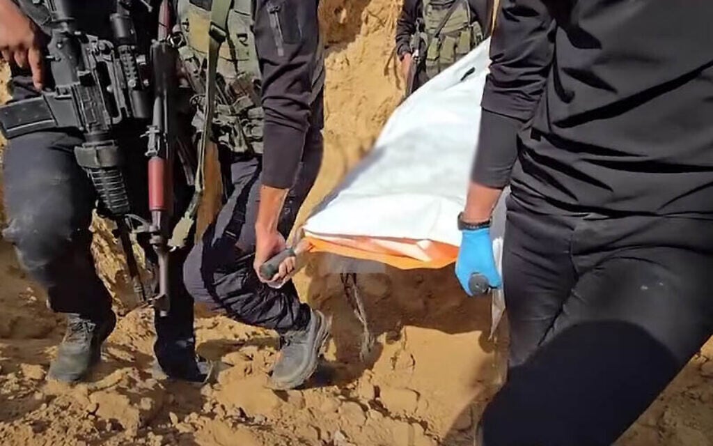 Footage released on social media on November 2, 2025, showing the apparent retrieval of remains of a deceased hostage held in Gaza. (Screenshot/Al-Arabiya via X) Footage released on social media on November 2, 2025, showing the apparent retrieval of remains of a deceased hostage held in Gaza. (Screenshot/Al-Arabiya via X)
