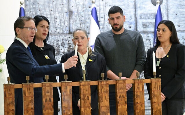 President Isaac Herzog and his wife, Michal, light the first candle of Hanukkah with the family of hostage Ran Gvili, December 14, 2025. (Kobi Gideon/GPO) President Isaac Herzog and his wife, Michal, light the first candle of Hanukkah with the family of hostage Ran Gvili, December 14, 2025. (Kobi Gideon/GPO)