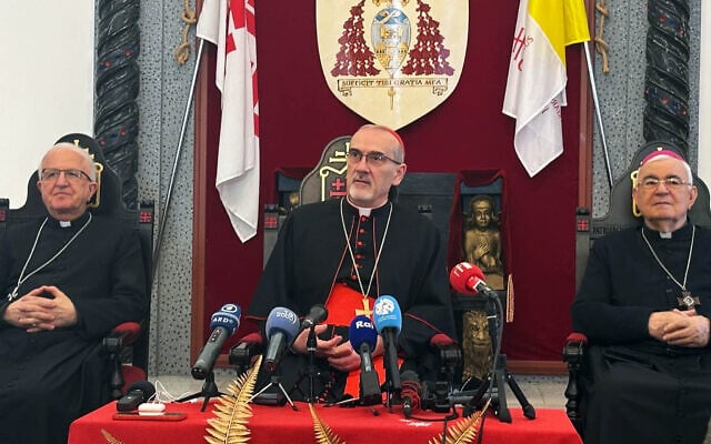 Latin Patriarch Cardinal Pierbattista Pizzaballa (center) and Patriarchal Vicar for Jerusalem, the West Bank and Gaza Bishop William Shomali (left) speak to reporters at the Latin Patriarchate in Jerusalem, December 22, 2025. (Lazar Berman/The Times of Israel)