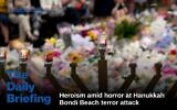 Candles burn in front of mourners as they gather at a tribute at the Bondi Pavilion in memory of the victims of a terror attack against Jews during a Hanukkah event at Bondi Beach, in Sydney on December 16, 2025. (SAEED KHAN / AFP)