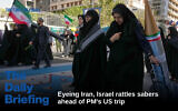 IMAGE: Demonstrators walk on an image of the Israeli flag with blood dripping from the Star of David as one of them carries a replica of a missile during an annual rally in front of the former US Embassy in Tehran, celebrating the anniversary of the 1979 takeover of the embassy, November 4, 2025. (AP/Vahid Salemi)