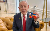 Prime Minister Benjamin Netanyahu holds up a Bugs Bunny doll in a video decrying his ongoing trial on corruption charges, December 4, 2025. (X screenshot)