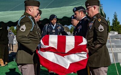 US Army honor guard members begin to settle the casket of Morton Sher into a grave at a cemetery in Greenville, South Carolina, Dec. 14, 2025. (Air Force Senior Airman Savannah Carpenter/US Department of War)