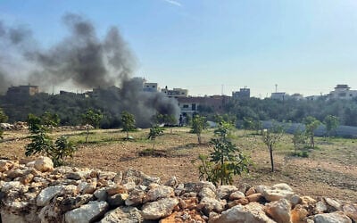 Palestinians burn electronic waste illegally near Azzoun, in the Qalqilya Governorate, northern West Bank, November 24, 2025. (Sue Surkes/Times of Israel)