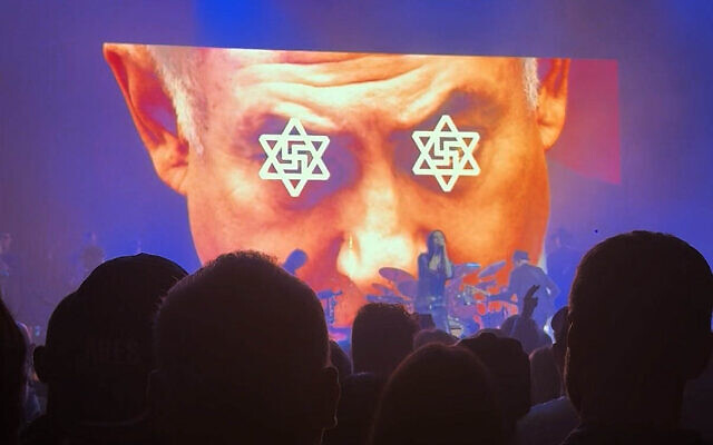 A video shown on stage of with an image of swastikas in the centre of Stars of David superimposed over the eyes of Prime Minister Benjamin Netanyahu, during a performance by British band Primal Scream in London, December 8, 2025. (Screenshot/X) A video shown on stage of with an image of swastikas in the centre of Stars of David superimposed over the eyes of Prime Minister Benjamin Netanyahu, during a performance by British band Primal Scream in London, December 8, 2025. (Screenshot/X)