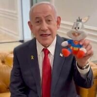 Prime Minister Benjamin Netanyahu holds up a Bugs Bunny doll in a video decrying his ongoing trial on corruption charges, December 4, 2025. (X screenshot)