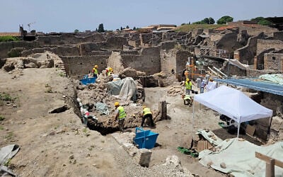 This handout photo taken on June 25, 2023, by Parco Archeologico di Pompei (Archaeological Park of Pompeii), shows workers excavating an archaeological site. (Handout / Parco Archeologico di Pompei press office / AFP)