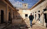 A local walks past cells as he guides journalists visiting the Palmyra Prison Complex formerly used by the ousted Assad government in Syria's central city of Palmyra on February 7, 2025.(OMAR HAJ KADOUR / AFP, file)