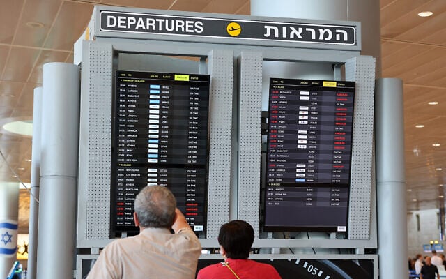 Illustrative: Passengers consult the departures board at Israel's Ben Gurion Airport on June 25, 2025. (Jack GUEZ / AFP) Illustrative: Passengers consult the departures board at Israel's Ben Gurion Airport on June 25, 2025. (Jack GUEZ / AFP)
