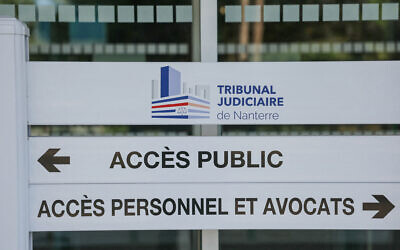 This photograph shows a sign reading "public access" and "personnel access and lawyers" at the entrance of the Judicial Court in Nanterre, Paris' suburb, on July 29, 2025. (Thomas Samson/AFP)