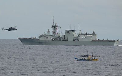 A CH-148 Cyclone helicopter approaches the Royal Canadian Navy frigate HMCS Ville de Quebec for landing during a maritime cooperative activity between the Philippines, Australia and Canadian navies near Scarborough Shoal in disputed waters of the South China Sea on September 2, 2025.  (Ted ALJIBE / AFP)