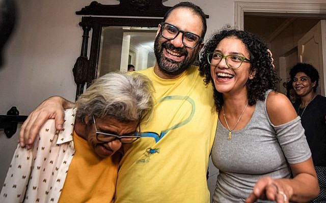 British-Egyptian activist Alaa Abd El Fattah (center) embraces his mother, writer Laila Soueif (left), and his sister Sanaa Seif (right), at home after his release in Cairo, Egypt, on September 23, 2025. (MOHAMED EL-RAAI / AFP) British-Egyptian activist Alaa Abd El Fattah (center) embraces his mother, writer Laila Soueif (left), and his sister Sanaa Seif (right), at home after his release in Cairo, Egypt, on September 23, 2025. (MOHAMED EL-RAAI / AFP)