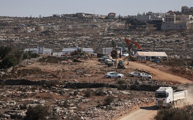 Illustrative: Trucks and heavy machinery are seen at a new Israeli settlement outpost near the settlements of Kiryat Arba'a and Kharsina, on the outskirts of the Palestinian city of Hebron in the southern West Bank on October 30, 2025. (HAZEM BADER / AFP) Illustrative: Trucks and heavy machinery are seen at a new Israeli settlement outpost near the settlements of Kiryat Arba'a and Kharsina, on the outskirts of the Palestinian city of Hebron in the southern West Bank on October 30, 2025. (HAZEM BADER / AFP)