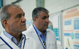 This handout picture made available by the Iranian Atomic Organization (IAEO) office on November 2, 2025, shows the Iranian President Masoud Pezeshkian (left) and Mohammad Eslami, head of the Atomic Energy Organization of Iran, during a visit to the Atomic Energy Organization of Iran, to meet with senior managers in the nuclear industry in Tehran, Iran. (Handout / various sources / AFP)