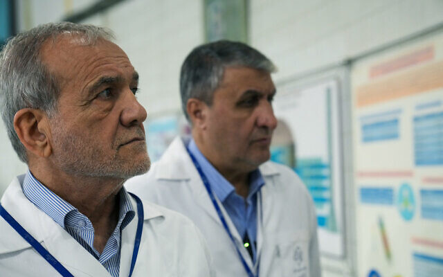 This handout picture made available by the Iranian Atomic Organization (IAEO) office on November 2, 2025, shows the Iranian President Masoud Pezeshkian (left) and Mohammad Eslami, head of the Atomic Energy Organization of Iran, during a visit to the Atomic Energy Organization of Iran, to meet with senior managers in the nuclear industry in Tehran, Iran. (Handout / various sources / AFP) This handout picture made available by the Iranian Atomic Organization (IAEO) office on November 2, 2025, shows the Iranian President Masoud Pezeshkian (left) and Mohammad Eslami, head of the Atomic Energy Organization of Iran, during a visit to the Atomic Energy Organization of Iran, to meet with senior managers in the nuclear industry in Tehran, Iran. (Handout / various sources / AFP)