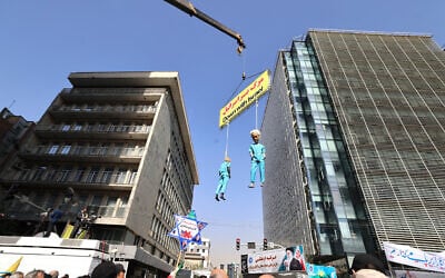 Illustration: Protestors stand under hanging figures depicting the US President Donald Trump and Prime Minister Benjamin Netanyahu during a rally outside the former US embassy in Tehran as Iranians mark the 46th anniversary of the start of the Iran hostage crisis, on November 4, 2025. (ATTA KENARE / AFP) Illustration: Protestors stand under hanging figures depicting the US President Donald Trump and Prime Minister Benjamin Netanyahu during a rally outside the former US embassy in Tehran as Iranians mark the 46th anniversary of the start of the Iran hostage crisis, on November 4, 2025. (ATTA KENARE / AFP)