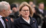 FILE: Victoria's Premier Jacinta Allan (R) listens to a speech during a Remembrance Day service at the Shrine of Remembrance in Melbourne on November 11, 2025. (William WEST / AFP)
