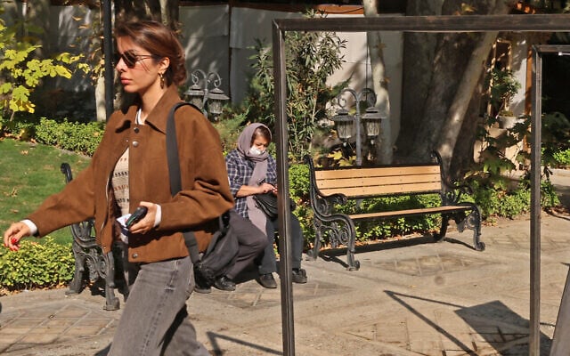 An unveiled woman walks outside the Cinema Museum during 'Tehran Design Week' in Tehran on November 17, 2025. (Atta KENARE / AFP) An unveiled woman walks outside the Cinema Museum during 'Tehran Design Week' in Tehran on November 17, 2025. (Atta KENARE / AFP)