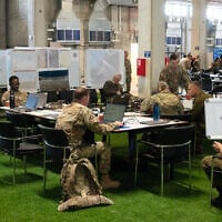 Personnel work at the Civil-Military Coordination Center (CMCC), a command center in the southern Israeli town of Kiryat Gat, on November 19, 2025. (Ahikam Seri / AFP)