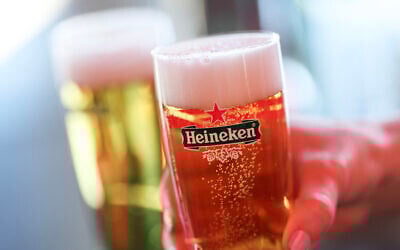 Illustrative: Guests hold glasses of Heineken beer in the paddock ahead of the first practice session for the Las Vegas Formula One Grand Prix at the Las Vegas Strip Circuit in Las Vegas, Nevada, on November 20, 2025. (Patrick T. Fallon / AFP)