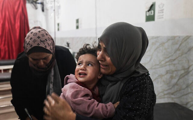 An injured Palestinian child in Al-Awda Hospital in the Nuseirat refugee camp in the central Gaza Strip, as casualties are brought into the medical facility following Israeli strikes, November 22, 2025. (Eyad Baba/AFP) An injured Palestinian child in Al-Awda Hospital in the Nuseirat refugee camp in the central Gaza Strip, as casualties are brought into the medical facility following Israeli strikes, November 22, 2025. (Eyad Baba/AFP)