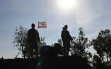This photograph taken during a press tour organized by the Lebanese army shows Lebanese soldiers standing atop a military vehicle in Alma Al-Shaab, near the border with Israel in southern Lebanon, on November 28, 2025. (Anwar AMRO / AFP)