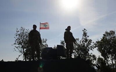 This photograph taken during a press tour organized by the Lebanese army shows Lebanese soldiers standing atop a military vehicle in Alma Al-Shaab, near the border with Israel in southern Lebanon, on November 28, 2025. (Anwar AMRO / AFP) This photograph taken during a press tour organized by the Lebanese army shows Lebanese soldiers standing atop a military vehicle in Alma Al-Shaab, near the border with Israel in southern Lebanon, on November 28, 2025. (Anwar AMRO / AFP)