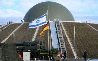 The flags of Israel and Germany fly in front of the Arrow 3 missile defense system and a radar dome during an event of the German Air Force at the Holzdorf Air Base, eastern Germany, on December 3, 2025. (RALF HIRSCHBERGER / AFP)