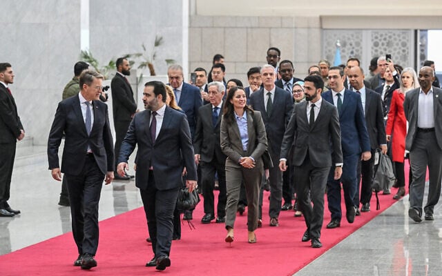Syrian Minister of Foreign Affairs and Expatriates Asaad Al-Shaibani (front right) arrives with a United Nations Security Council delegation at the Presidential Palace in Damascus on December 4, 2025. (LOUAI BESHARA / AFP)
