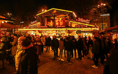 Illustrative: Visitors walk at the Christmas market in Dortmund, western Germany, on December 5, 2025. (Ina Fassbender/AFP)