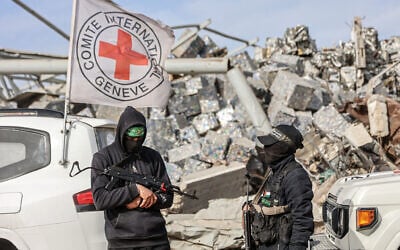 Hamas gunmen patrol as Egyptian workers, accompanied by members of the International Committee of the Red Cross (ICRC), search for the remains of the last Israeli hostage, Ran Gvili, in the Zeitoun neighborhood of Gaza City on December 8, 2025. (Omar AL-QATTAA / AFP)