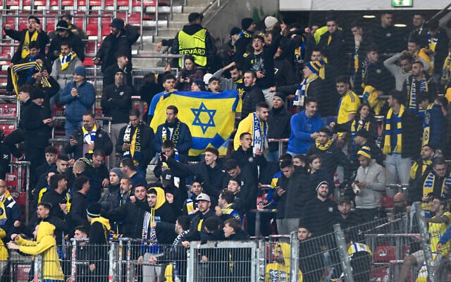 Maccabi Tel Aviv's fans cheer their team as it arrives to inspect the pitch prior to the UEFA Europa League football match between VfB Stuttgart and Maccabi Tel Aviv in Stuttgart, southern Germany, on December 11, 2025. (Thomas Kienzle/AFP) Maccabi Tel Aviv's fans cheer their team as it arrives to inspect the pitch prior to the UEFA Europa League football match between VfB Stuttgart and Maccabi Tel Aviv in Stuttgart, southern Germany, on December 11, 2025. (Thomas Kienzle/AFP)
