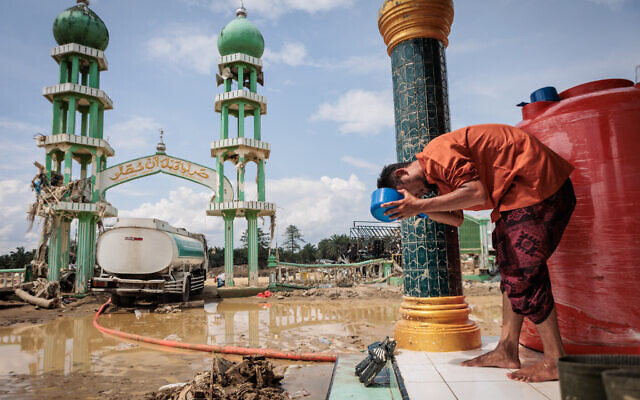 A Muslim man washes his face before attending Friday prayers at Al Ihsan Mosque, which was partially damaged by flooding, in Aceh Tamiang, North Sumatra, Indonesia, on December 12, 2025. (Aditya Aji / AFP) A Muslim man washes his face before attending Friday prayers at Al Ihsan Mosque, which was partially damaged by flooding, in Aceh Tamiang, North Sumatra, Indonesia, on December 12, 2025. (Aditya Aji / AFP)