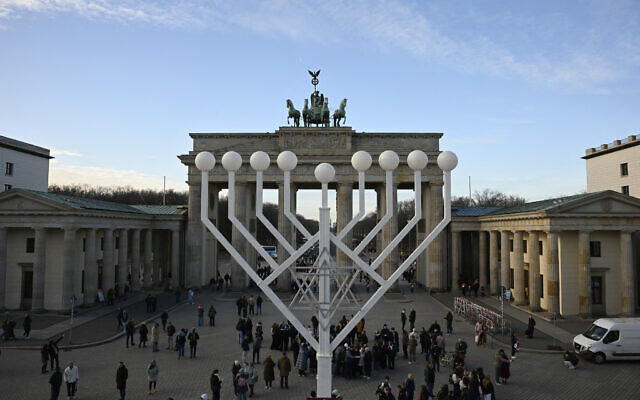 A giant menorah is set up in front of the Brandenburg Gate in Berlin on December 12, 2025, as preparations are under way for Hanukkah. (Tobias SCHWARZ / AFP) A giant menorah is set up in front of the Brandenburg Gate in Berlin on December 12, 2025, as preparations are under way for Hanukkah. (Tobias SCHWARZ / AFP)