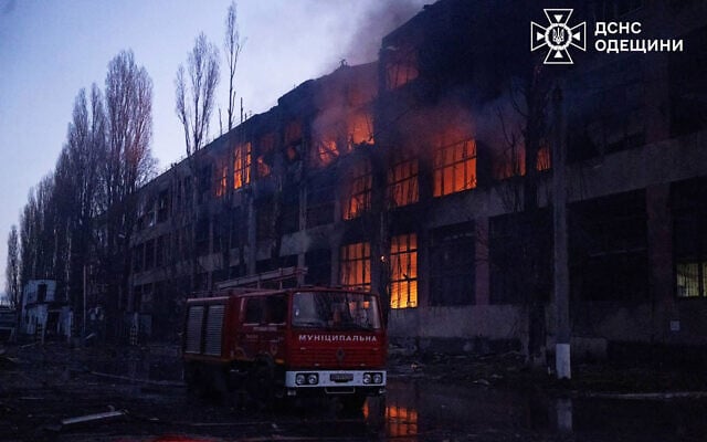 In this handout photograph taken and released by the Ukrainian Emergency Service on December 13, 2025, a fire truck is parked next to a burning building following an air attack at an undisclosed location in the Odesa region, amid the Russian invasion of Ukraine. (Handout / UKRAINIAN EMERGENCY SERVICE / AFP) In this handout photograph taken and released by the Ukrainian Emergency Service on December 13, 2025, a fire truck is parked next to a burning building following an air attack at an undisclosed location in the Odesa region, amid the Russian invasion of Ukraine. (Handout / UKRAINIAN EMERGENCY SERVICE / AFP)