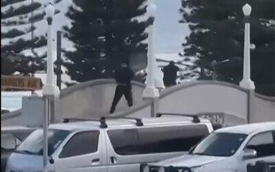 This screen grab made from UGC handout video footage courtesy of Timothy Brant-Coles shows two gunmen dressed in black firing multiple shots on a bridge at Bondi Beach in Sydney on December 14, 2025, in an attack on a Hanukkah event. (Handout / various sources / AFP) This screen grab made from UGC handout video footage courtesy of Timothy Brant-Coles shows two gunmen dressed in black firing multiple shots on a bridge at Bondi Beach in Sydney on December 14, 2025, in an attack on a Hanukkah event. (Handout / various sources / AFP)