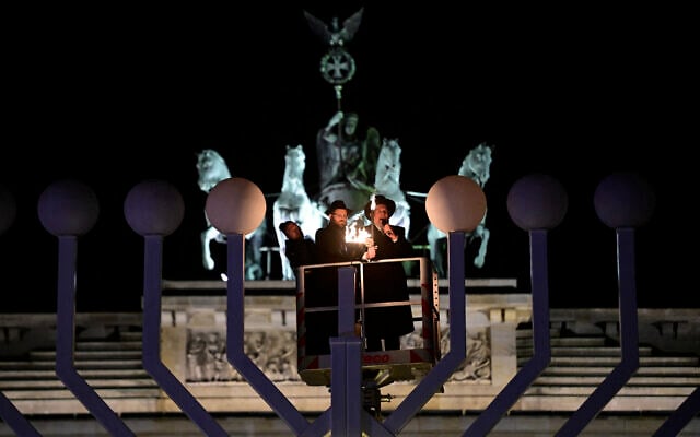 The lighting of a Hanukkiah in front of the Brandenburg Gate in Berlin on December 14, 2025. (John MACDOUGALL / AFP)