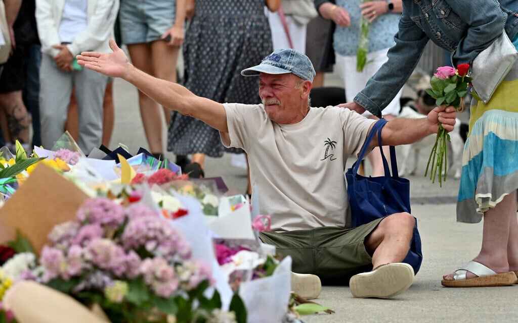 A mourner reacts as he pays a floral tribute to Bondi Beach terror attack victims at the Bondi Pavilion in Sydney on December 15, 2025. (Saeed KHAN / AFP) A mourner reacts as he pays a floral tribute to Bondi Beach terror attack victims at the Bondi Pavilion in Sydney on December 15, 2025. (Saeed KHAN / AFP)