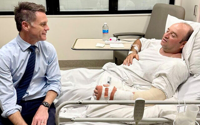 This handout photo taken and received from the NSW Premier's Department on December 15, 2025, shows New South Wales Premier Chris Minns (L) talking with Ahmed Al Ahmed, the man who tackled and disarmed one of the Bondi Beach terrorists, at St. George Hospital in Sydney. (Handout/ NSW Premier's Department/AFP) This handout photo taken and received from the NSW Premier's Department on December 15, 2025, shows New South Wales Premier Chris Minns (L) talking with Ahmed Al Ahmed, the man who tackled and disarmed one of the Bondi Beach terrorists, at St. George Hospital in Sydney. (Handout/ NSW Premier's Department/AFP)