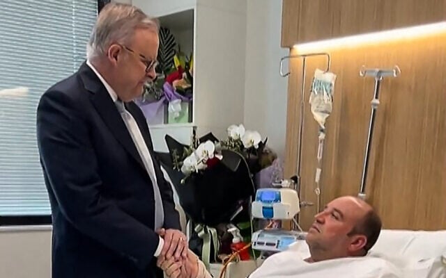 This frame grab from a video posted on the X account of Australia's Prime Minister Anthony Albanese taken and released on December 16, 2025 shows Albanese (L) meeting Ahmed al Ahmed, the man who disarmed one of the attackers during the Bondi beach terror attack, in hospital in Sydney (X ACCOUNT of @AlboMP / AFP)