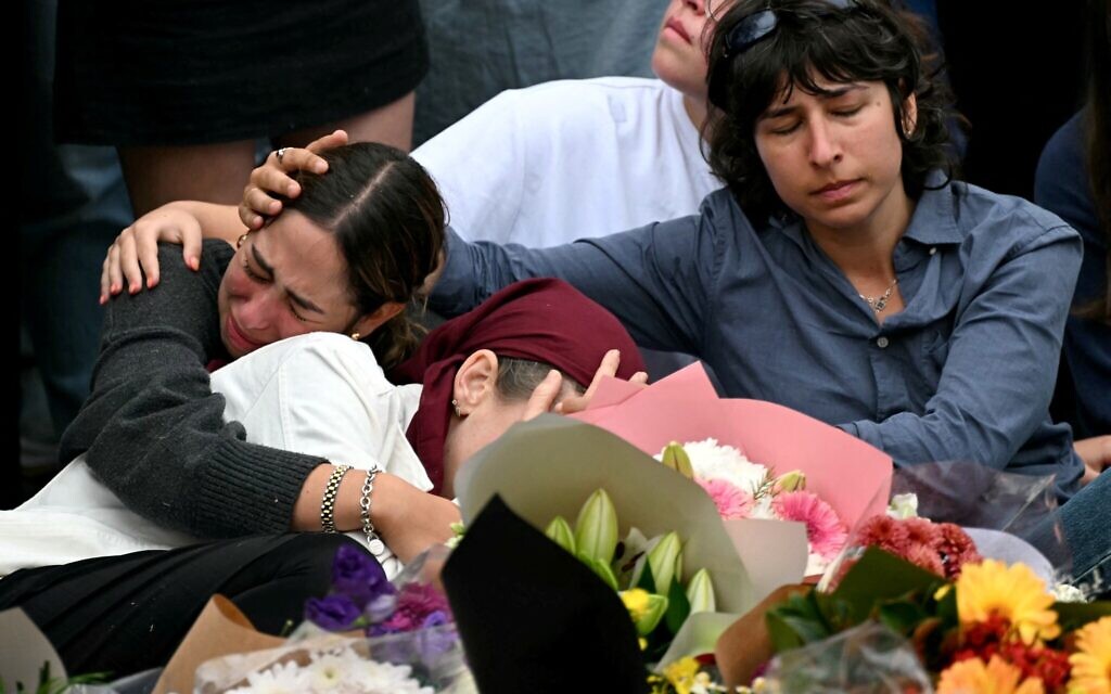 Family members of victims at a memorial for victims of the Hanukkah terror attack at Bondi Beach, in Sydney on December 16, 2025 (Saeed KHAN / AFP)